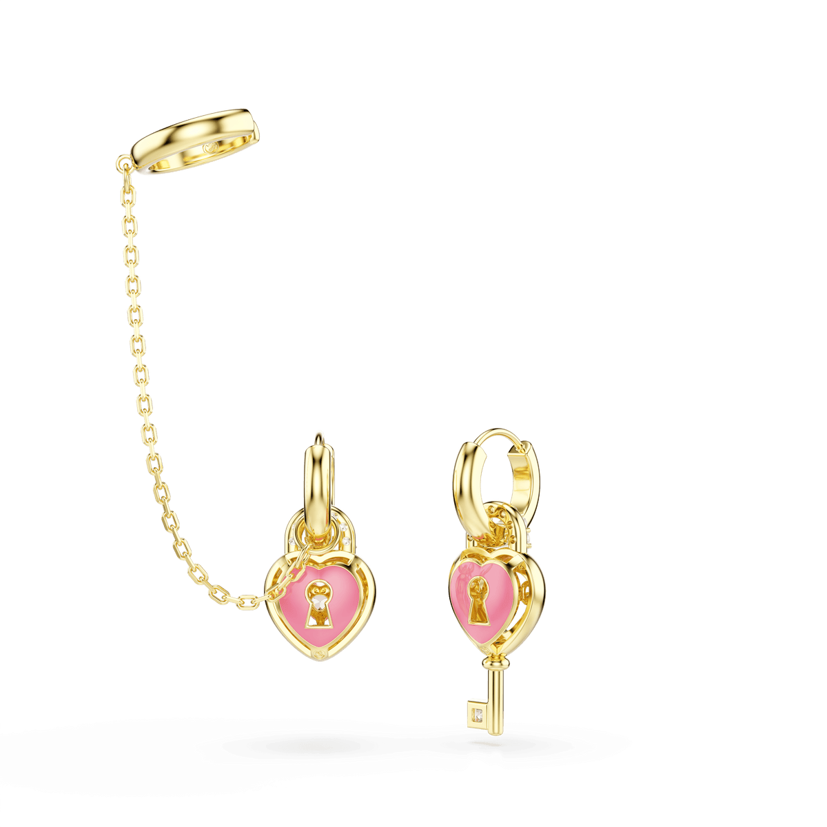 The Swarovski Idyllia drop earrings with ear cuff feature mixed-cut pink hearts with key designs and an elegant 18K gold finish. One earring displays a dangling gold chain and ring, while the other showcases a small gold key hanging from the heart charm. This exquisite pair of earrings by Swarovski is shown against a white background.