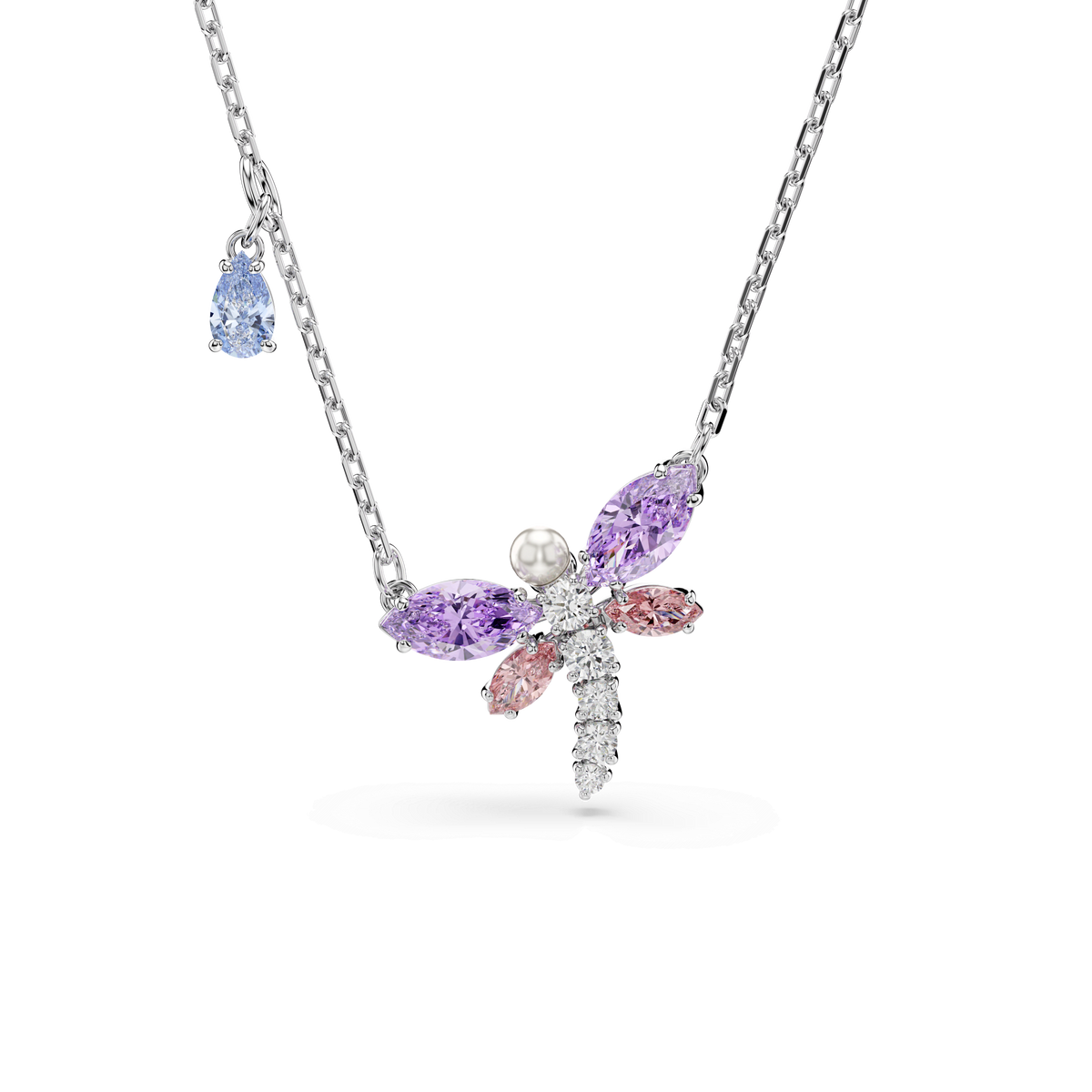 The Swarovski Ariana Grande x Swarovski pendant is a multicolored dragonfly necklace crafted in rhodium plating, featuring mixed-cut gemstones in purple and pink, a white gemstone body, and a blue teardrop-shaped Swarovski Zirconia accent on the chain, shown against a white background.