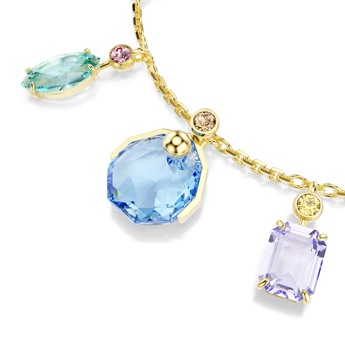 A gold chain necklace featuring blue, lavender, and teal gemstone pendants in varying shapes, accented by small round pink and yellow stones, pairs beautifully with the Swarovski Gema bracelet—a vibrant piece adorned with multicolored dangling crystals of mixed cuts and finished in 18K gold.