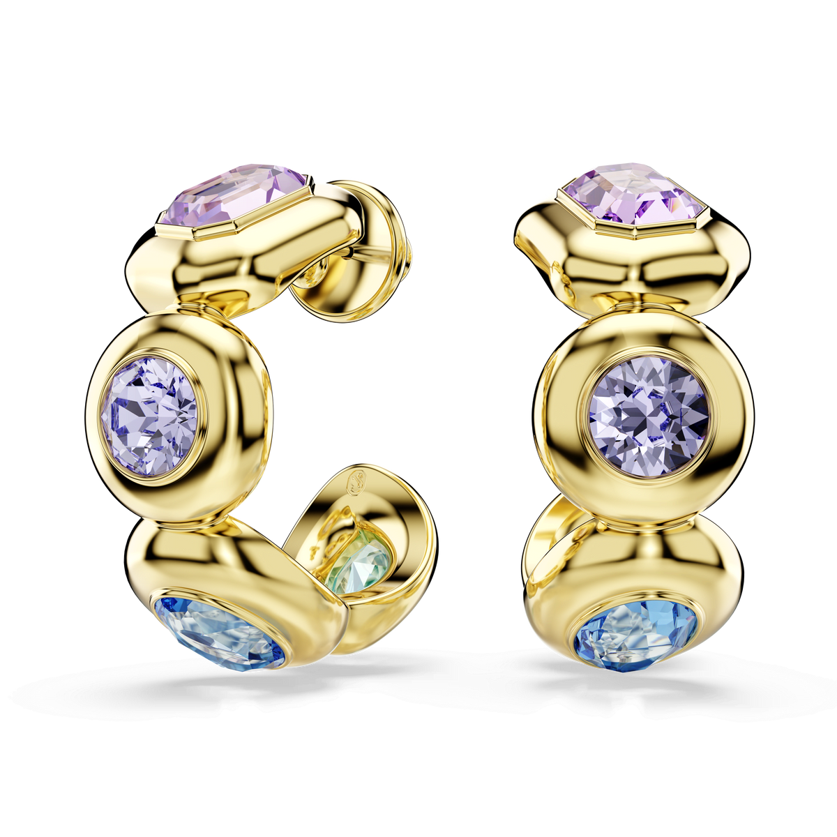 Close-up of the Swarovski Gema hoop earrings by Swarovski, showcasing mixed-cut, multicolored gemstones in pastel hues of purple, blue, and green—each sparkling brilliantly with signature Swarovski crystals—set in smooth, circular 18K gold-finished settings against a plain white background.