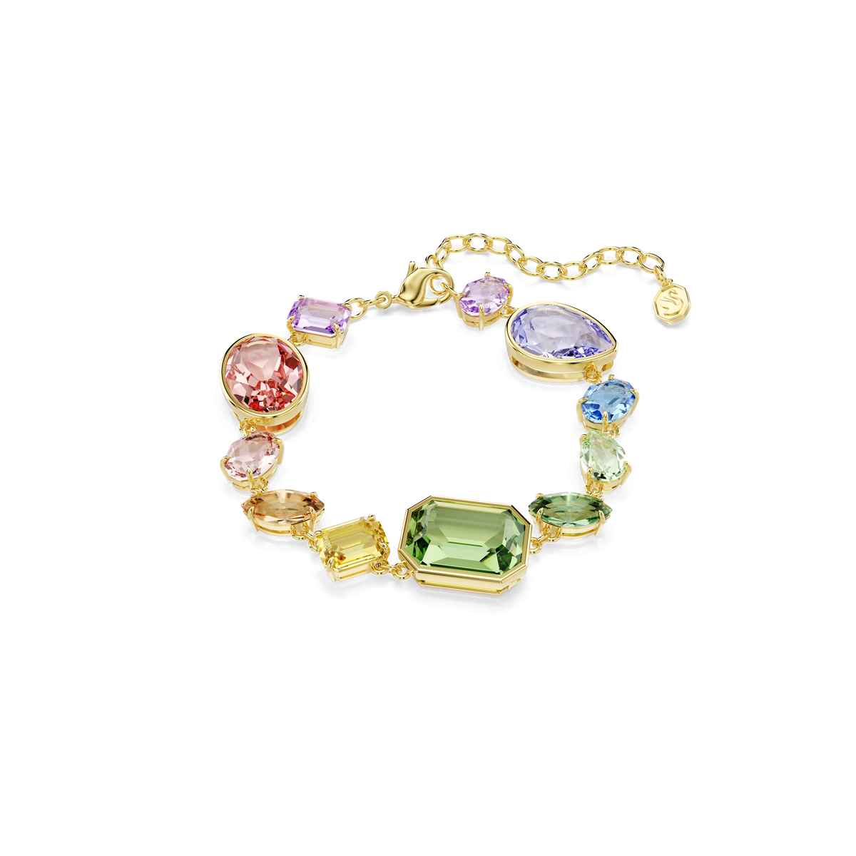 The Swarovski Gema bracelet by Swarovski features a stunning 18K gold finish and an elegant design with mixed cuts of multicolored crystals—pear, emerald, oval, and round—beautifully linked together against a plain light gray background.
