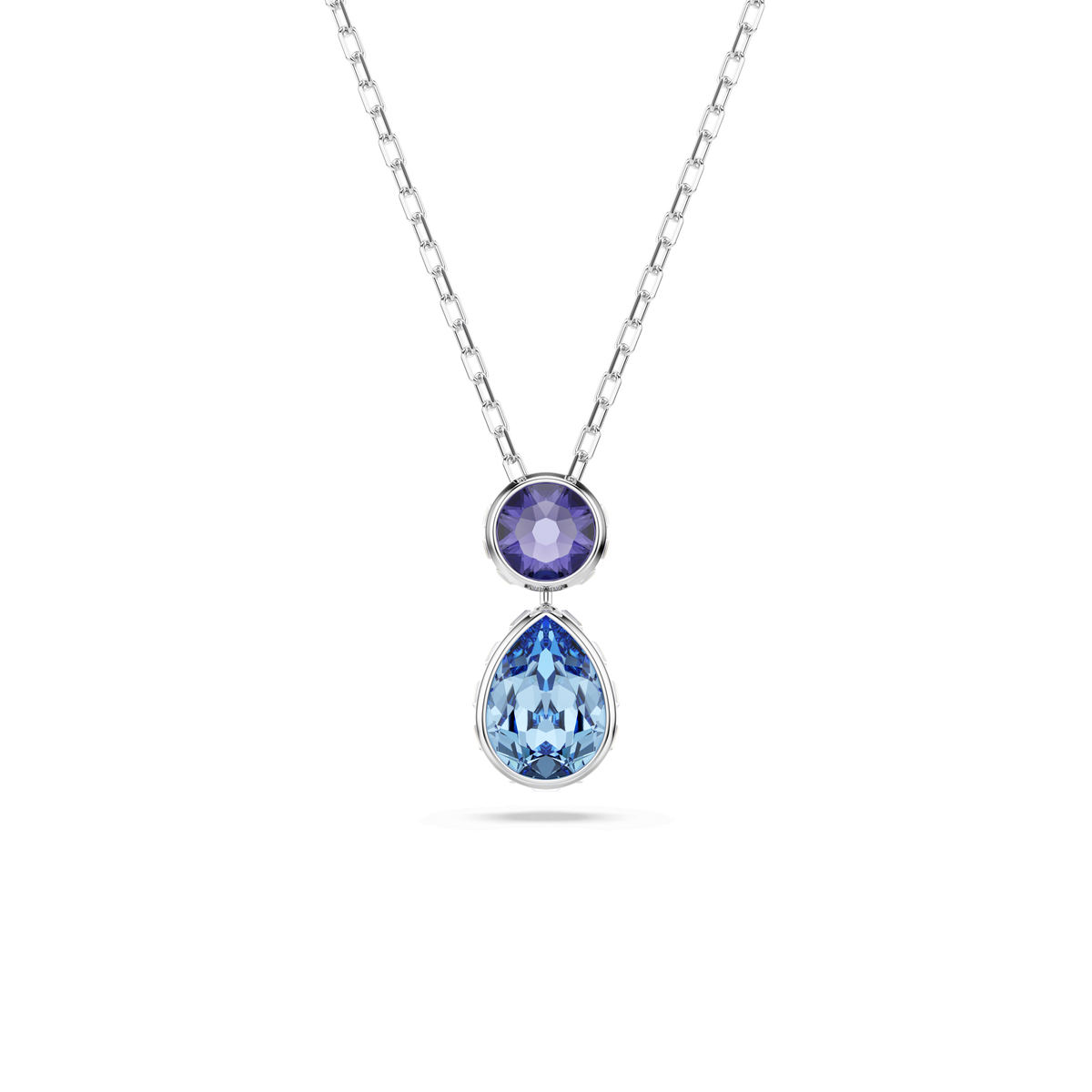 Introducing the Swarovski Chroma pendant: a multicolored necklace by Swarovski, showcasing mixed-cut crystals in vibrant purple and blue hues—one round purple crystal sits elegantly above a teardrop-shaped blue gemstone, both set in sleek rhodium-plated bezels against a white background.