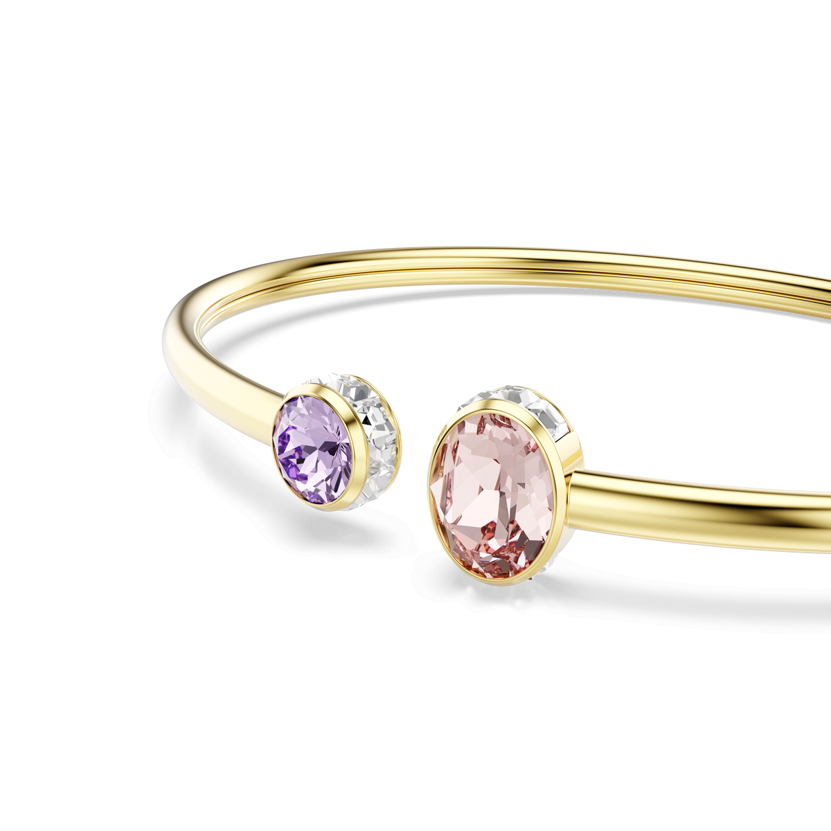 The Swarovski Chroma bangle features mixed-cut gemstones in vibrant pink and purple crystal, each set in bezel settings and finished with radiant 18K gold. This multicolored Swarovski creation is elegantly displayed against a white background.