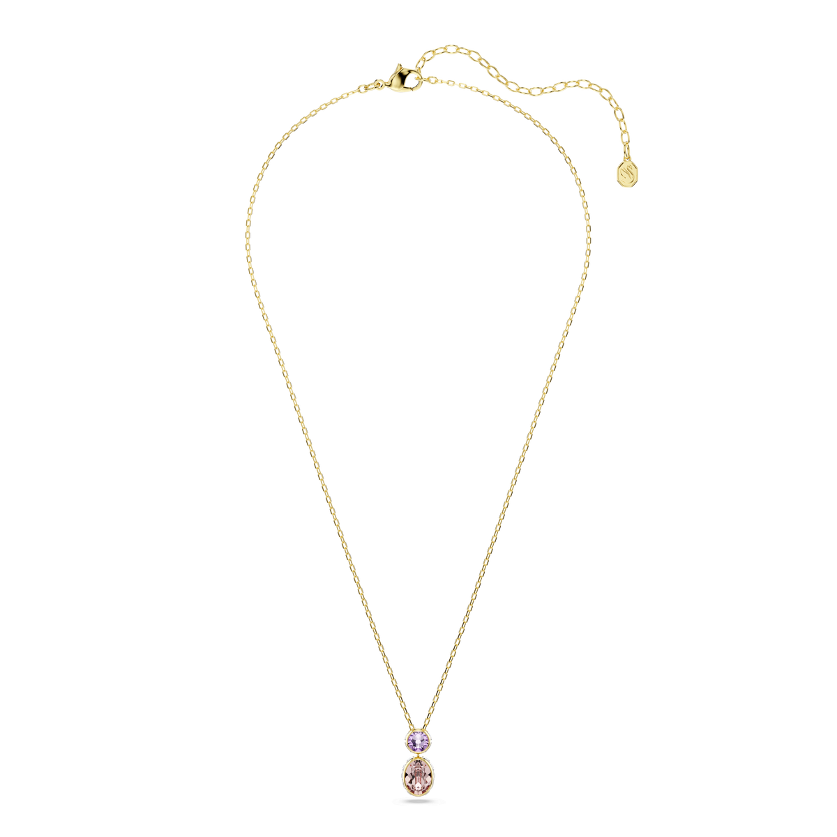 A delicate Swarovski Chroma pendant necklace, featuring mixed-cut multicolored gemstones—one larger oval pale pink and one smaller round purple stone—set in an 18K gold finish, is displayed on a white background. The refined design takes inspiration from the elegant silhouette of a classic Swarovski pendant.