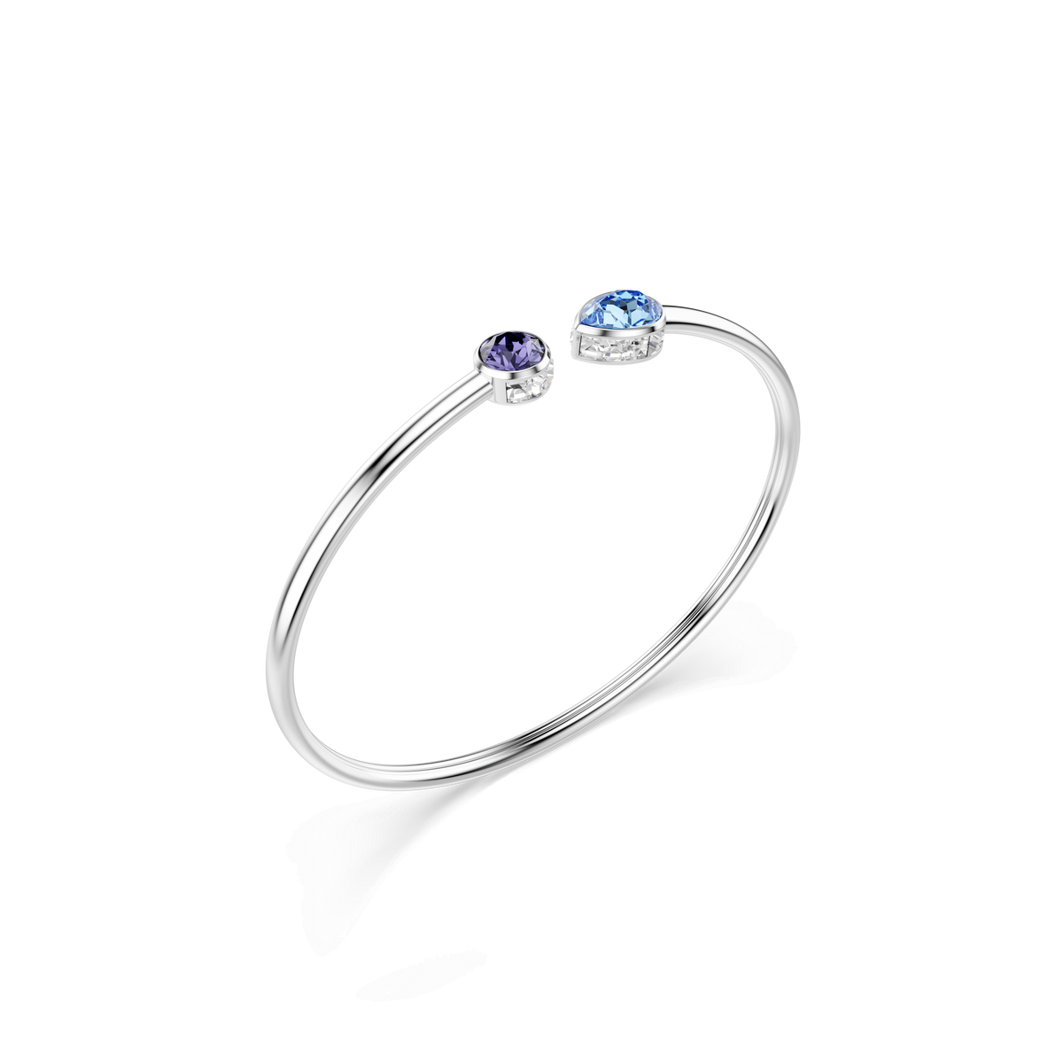 A minimalist Swarovski Chroma bangle featuring mixed-cut multicolored crystals at each open end, elegantly set in simple prongs and finished with a sleek rhodium-plated shine.