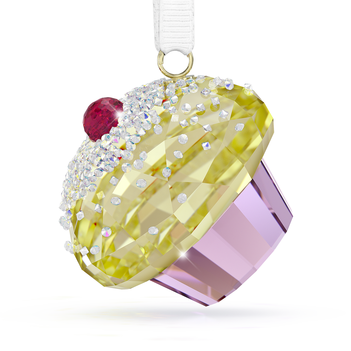 The Swarovski Holiday Cheers Dulcis Cupcake Ornament by Swarovski features a faceted design with a yellow top, crystal cherry detail, and a light purple base with an enchanting Aurora Boreale effect, suspended from a white ribbon.