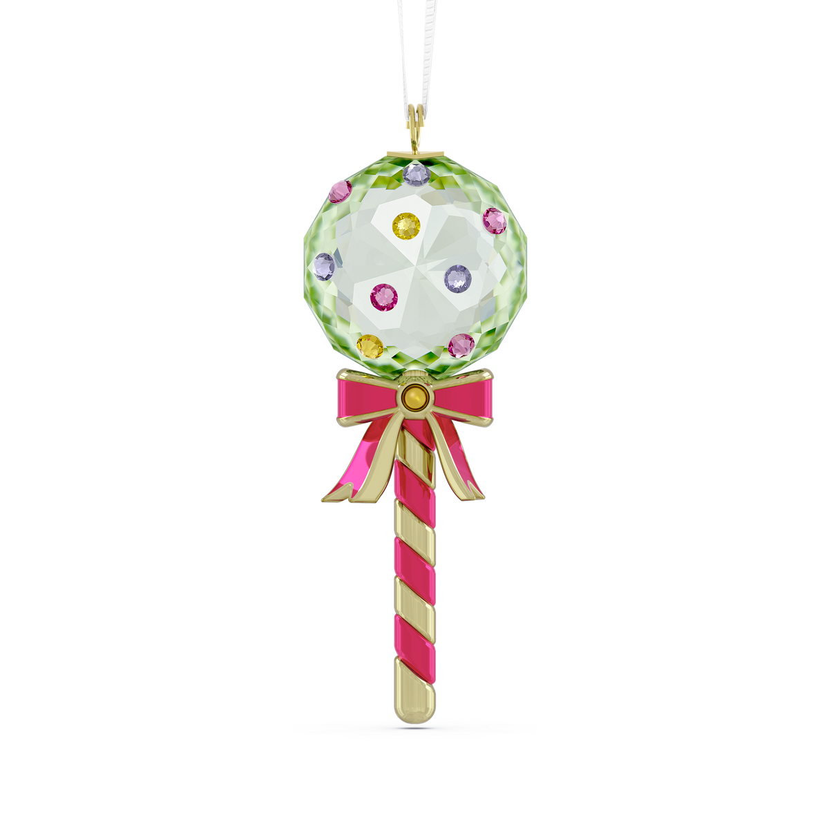 The Swarovski Holiday Cheers Dulcis Lollipop Ornament, Green, by Swarovski, features a green lollipop shape with a faceted top, colorful gem accents, decorative crystals, a pink and gold stick, and a pink bow. It is displayed hanging from a white string against a plain background.