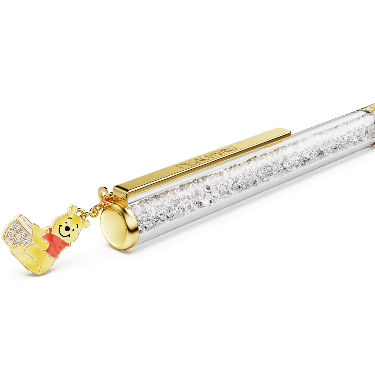 The Swarovski Crystalline ballpoint pen features yellow lacquer, gold-tone plating, and a charming gold and red Winnie the Pooh charm holding a pot of honey, all filled with sparkling clear crystals for a touch of Disney magic.