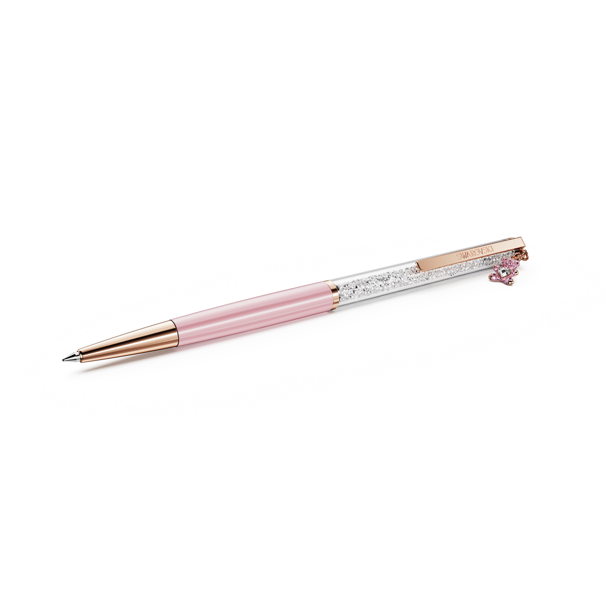 The Swarovski Crystalline ballpoint pen, Teddy, features a sleek pink lacquered design with rose gold-tone plating. Its barrel sparkles with signature Swarovski crystals, and a charming pink teddy bear accent adorns the clip. Presented against a white background.