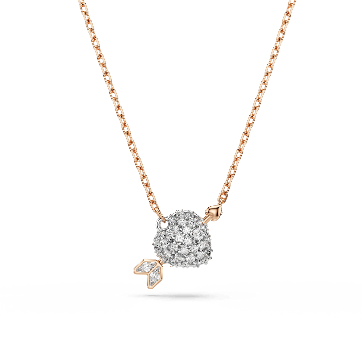 The Swarovski Idyllia set features a heart-shaped pendant accented with mixed-cut white stones and a diamond-like arrow detail, all elegantly finished in 18K rose gold by Swarovski, displayed on a plain white background.