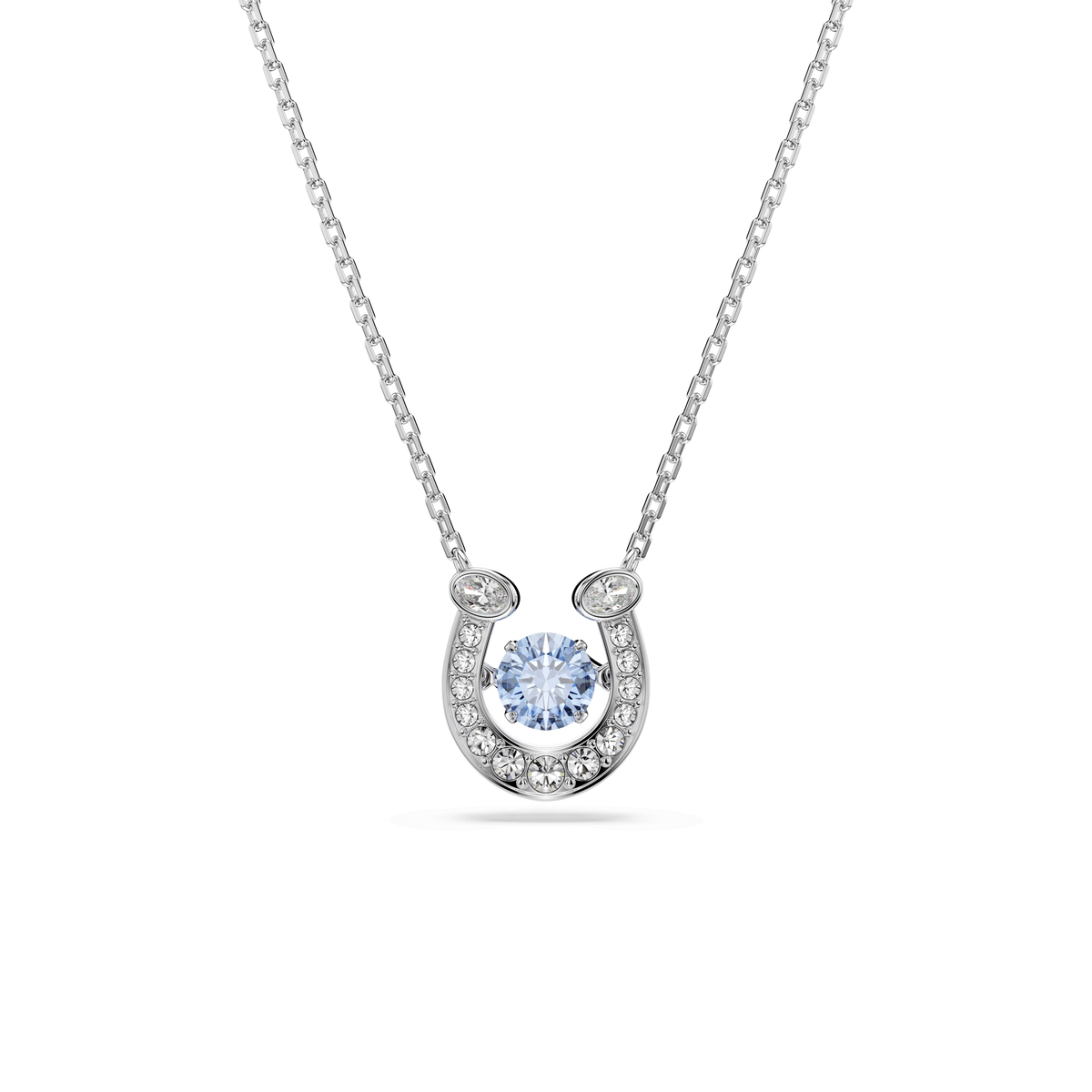 The Swarovski Symbolica pendant features a rhodium-plated horseshoe design adorned with pavé-set clear stones and a striking central round blue stone.