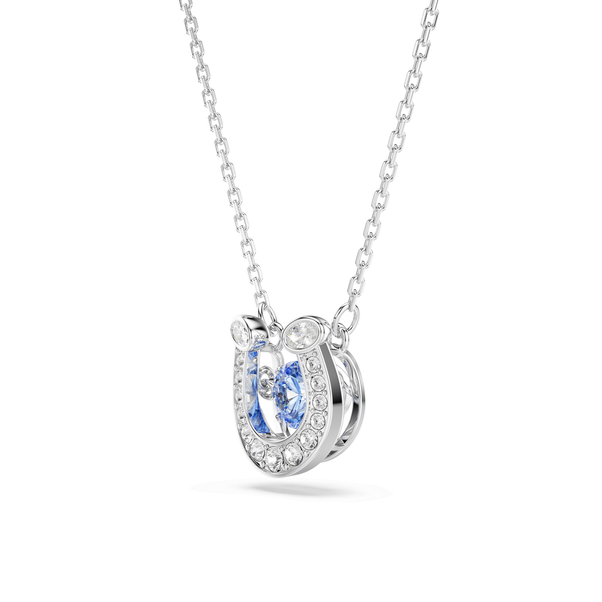 The Swarovski Symbolica pendant features a horseshoe design embellished with sparkling pavé clear gemstones and a striking blue round-cut center stone, all elegantly rhodium plated.