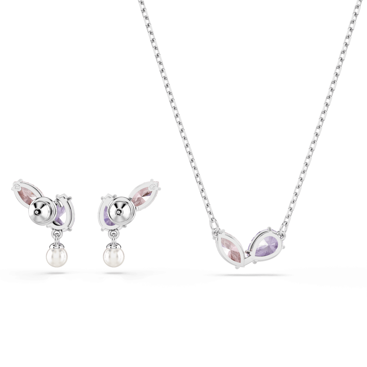 The Swarovski Ariana Grande x Swarovski set, featuring mixed-cut multicolored stones and rhodium plating, includes a stunning necklace with two marquise-shaped pink and purple stones and matching stud earrings adorned with similar stones and a dangling pearl. This elegant jewelry set from Swarovski is beautifully showcased against a white background.