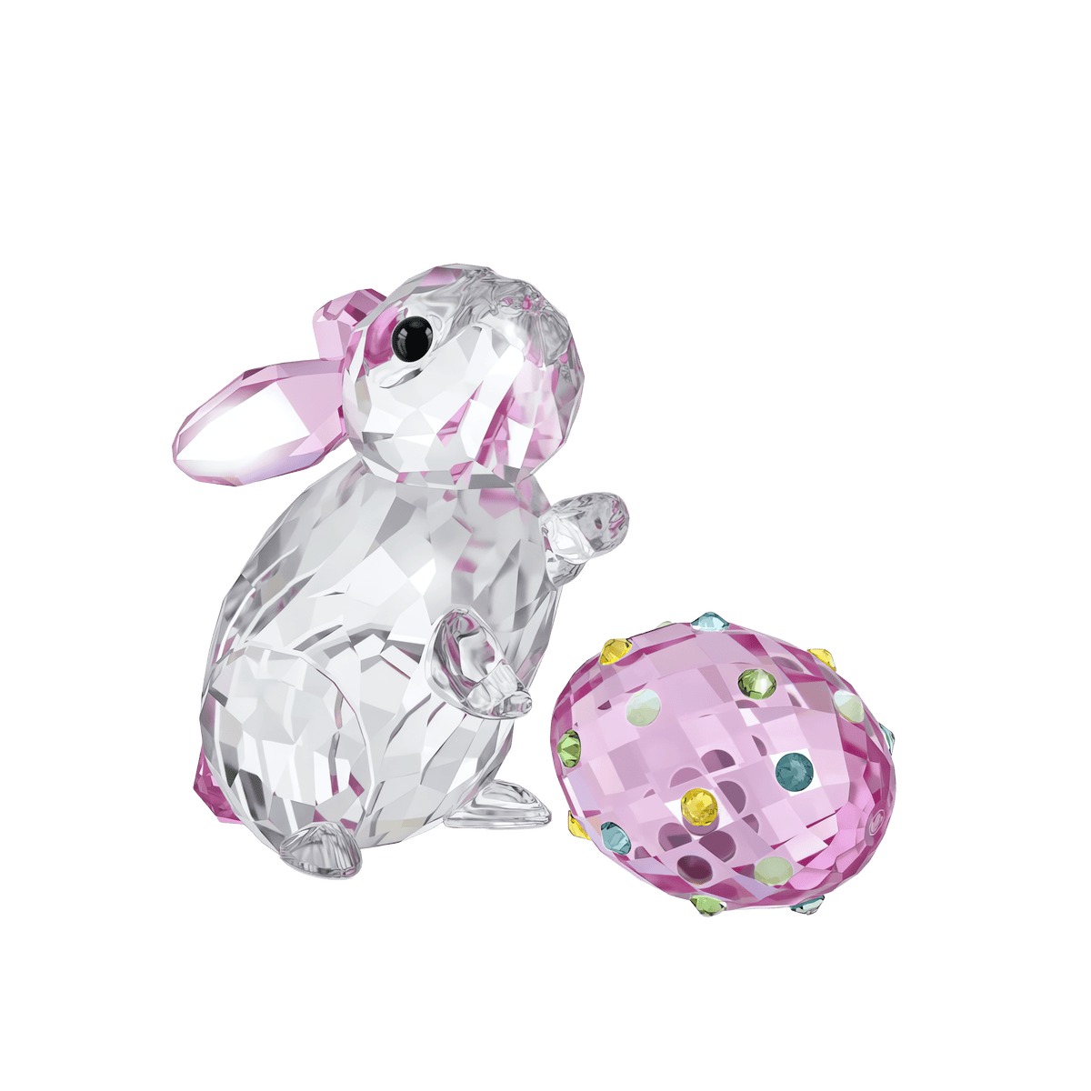 The Swarovski Idyllia Rabbit and Egg features a crystal rabbit figurine with pink ears and details, seated next to a jeweled egg adorned with colorful stones, all set against a white background—available at Raffi Jewellers, your trusted source for Swarovski Canada.
