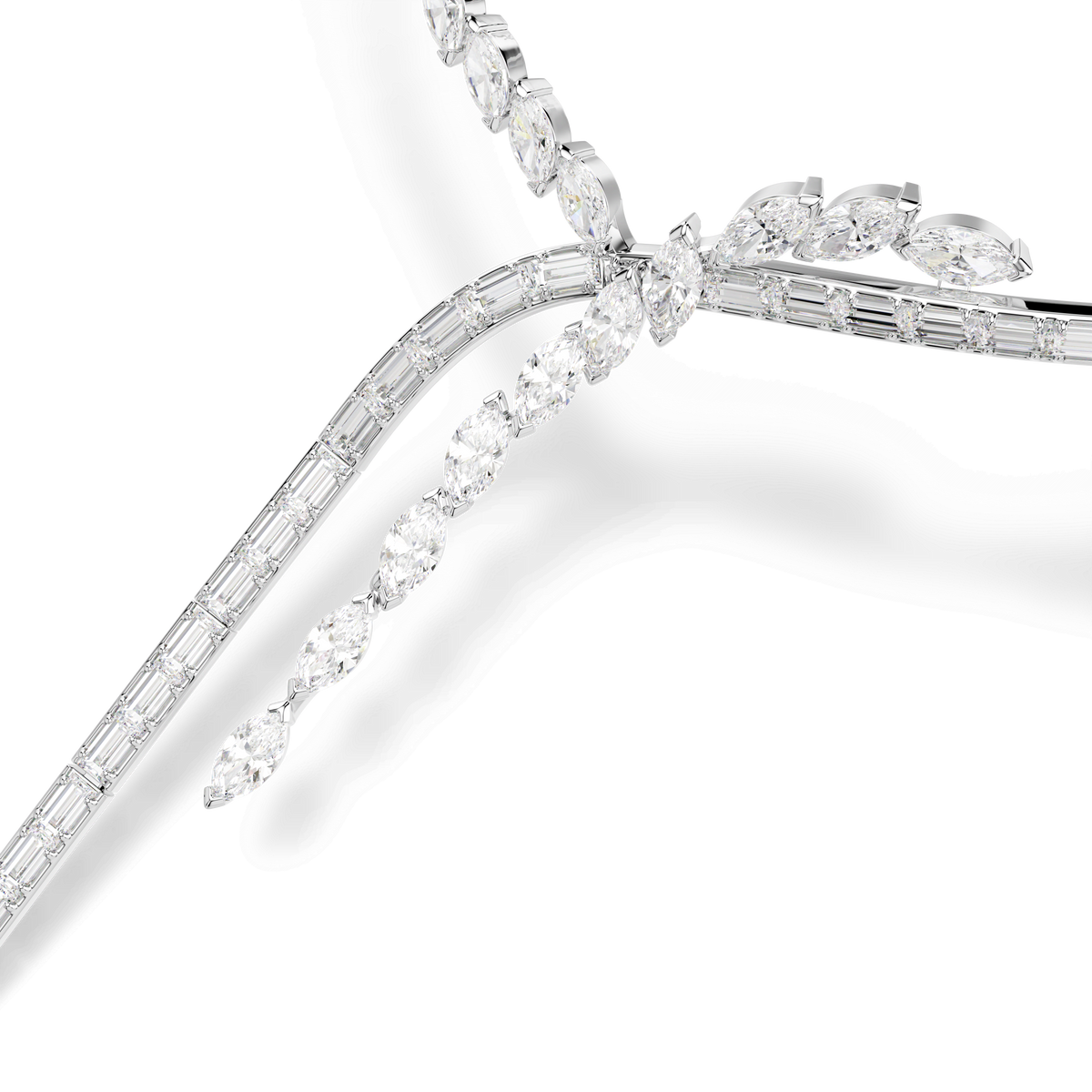 A close-up of the Swarovski Mesmera Y necklace by Swarovski, featuring a sophisticated Y-shape design with mixed-cut white Swarovski Zirconia gemstones set in rhodium plating, arranged in an intricate, overlapping pattern on a white background.
