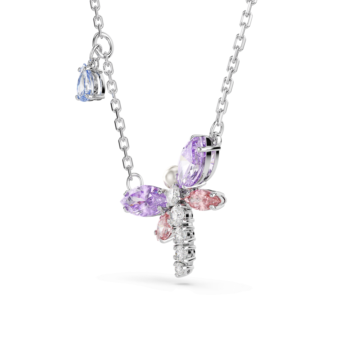 The Swarovski Ariana Grande x Swarovski pendant is a rhodium-plated silver chain necklace featuring a multicolored, mixed-cut dragonfly pendant adorned with pink, purple, and clear gemstones, along with a small blue Swarovski Zirconia charm on the chain.