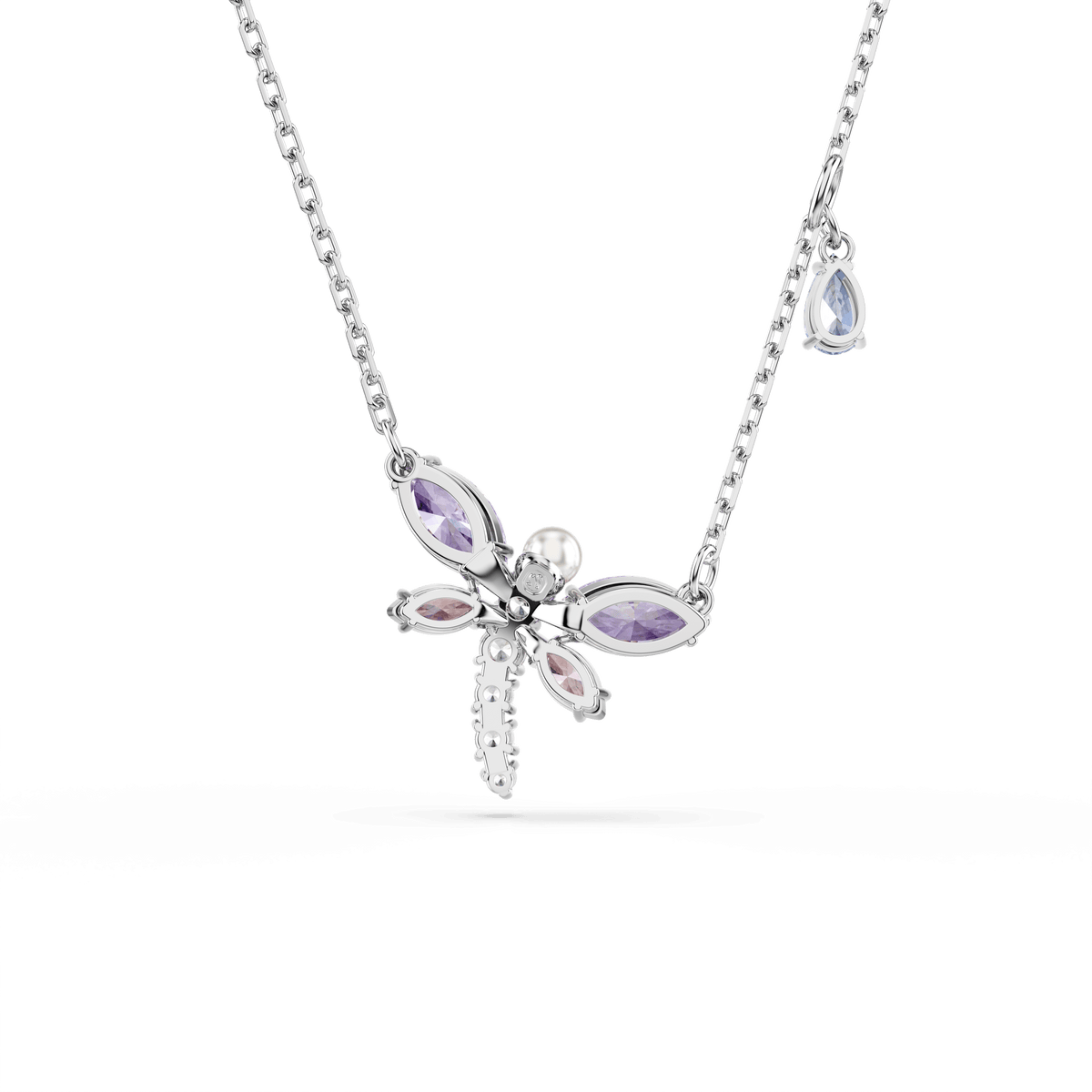 The Swarovski Ariana Grande x Swarovski pendant features a rhodium-plated dragonfly design adorned with multicolored mixed-cut crystals and a teardrop-shaped Swarovski Zirconia charm on the chain, all displayed on a white background.