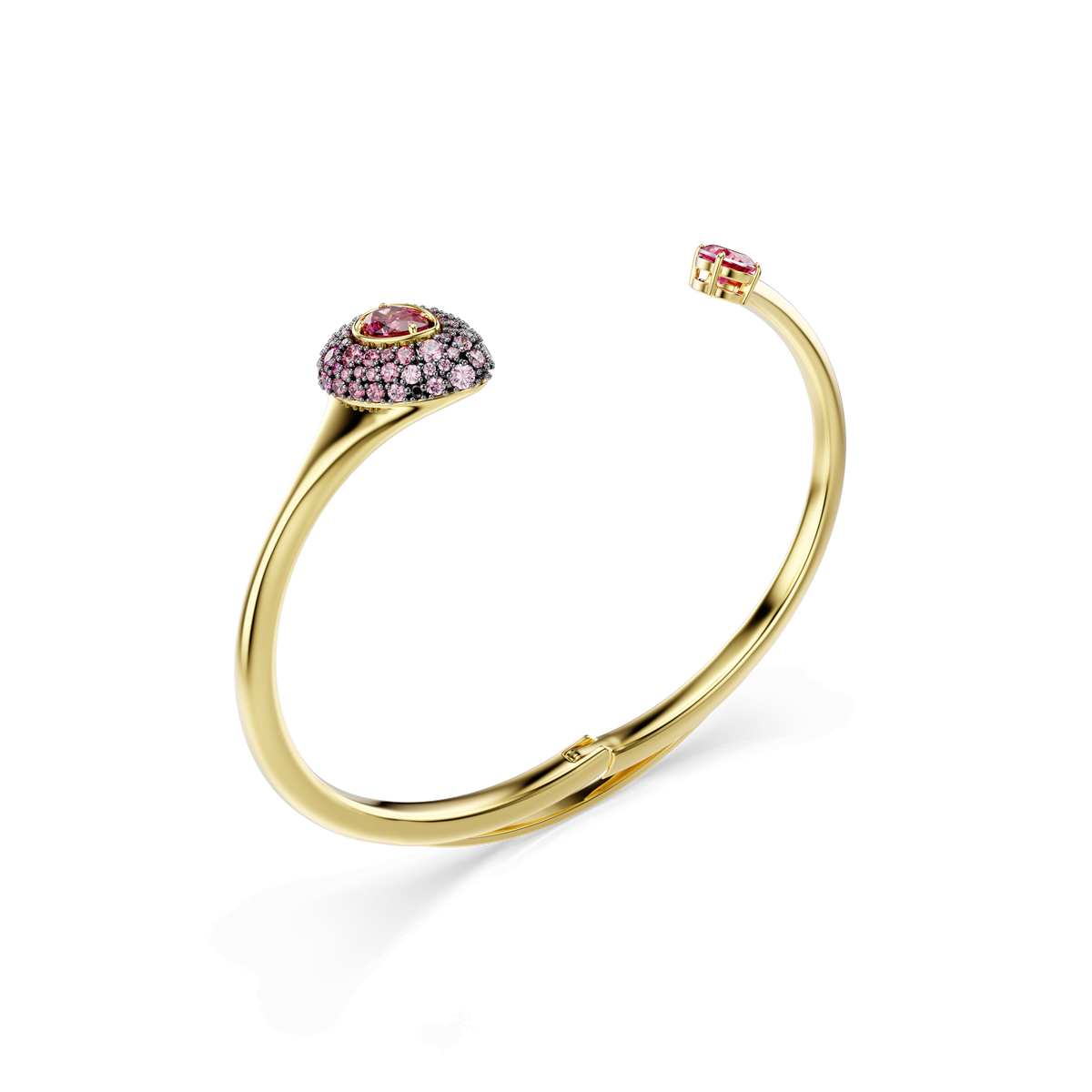 A Swarovski Sublima bangle with a pear-cut red Swarovski Zirconia, adorned in an 18K gold finish, is photographed on a white background.
