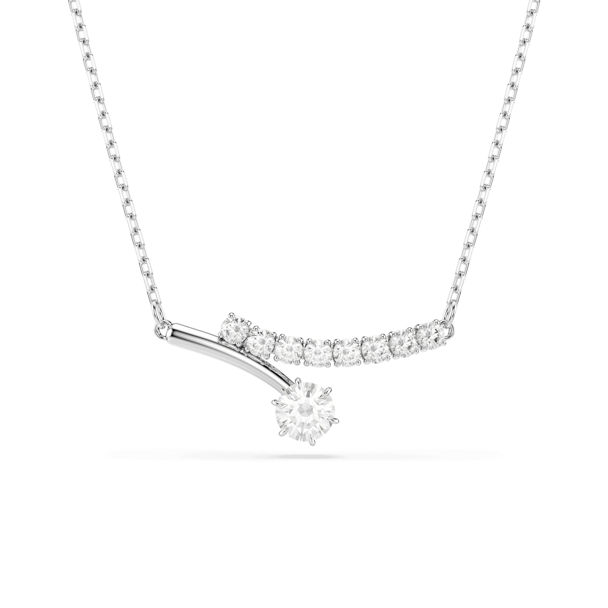 The Swarovski Matrix necklace by Swarovski features a round-cut, sparkling white stone as the centerpiece, accented by smaller stones trailing behind on a curved, rhodium-plated pendant.