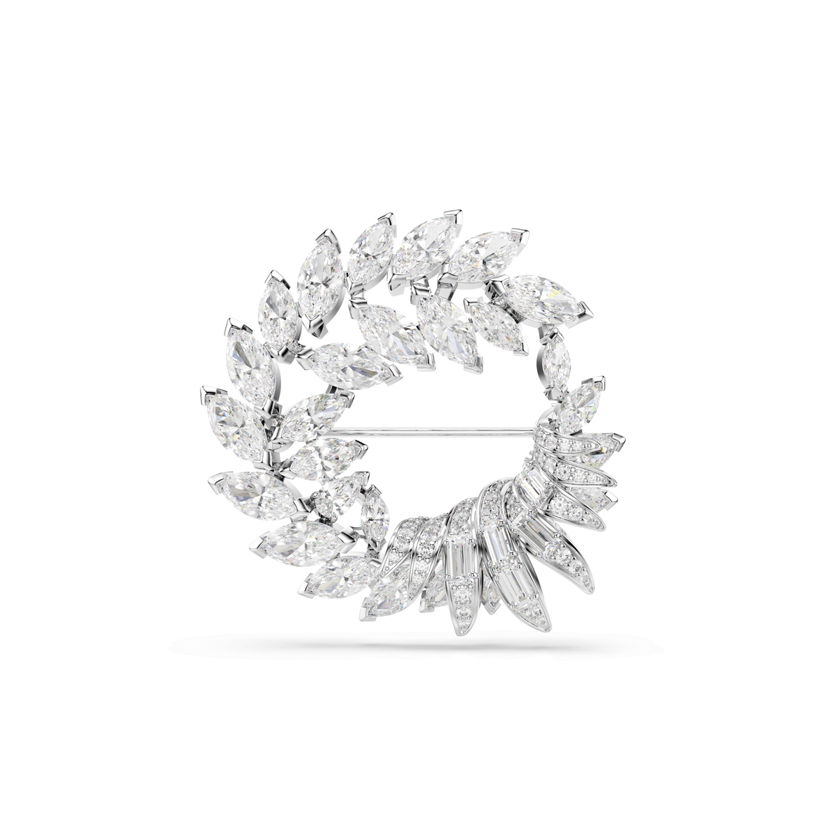 The Swarovski Mesmera brooch is a circular, rhodium-plated piece adorned with marquise-cut white crystals arranged in a wreath-like design, set against a plain white background.