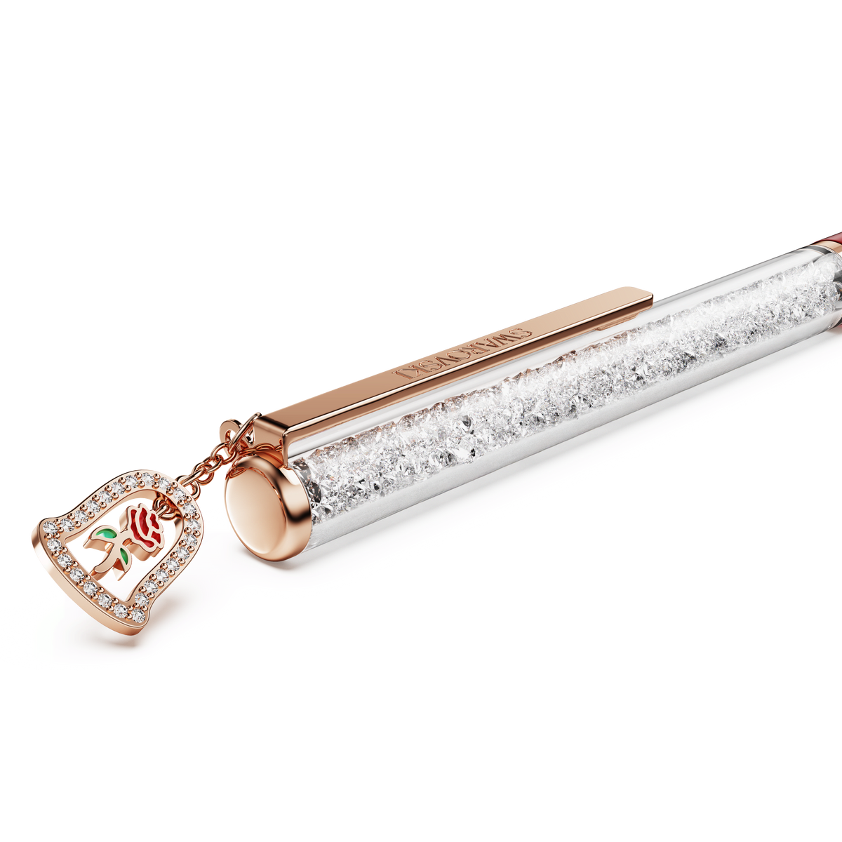 Introducing the Swarovski Crystalline Ballpoint Pen, Bell edition—a red lacquered pen finished with rose gold-tone plating, filled with sparkling clear crystals and adorned with a delicate charm inspired by an enchanted rose in a glass dome, capturing the magic of “Beauty and the Beast.”.