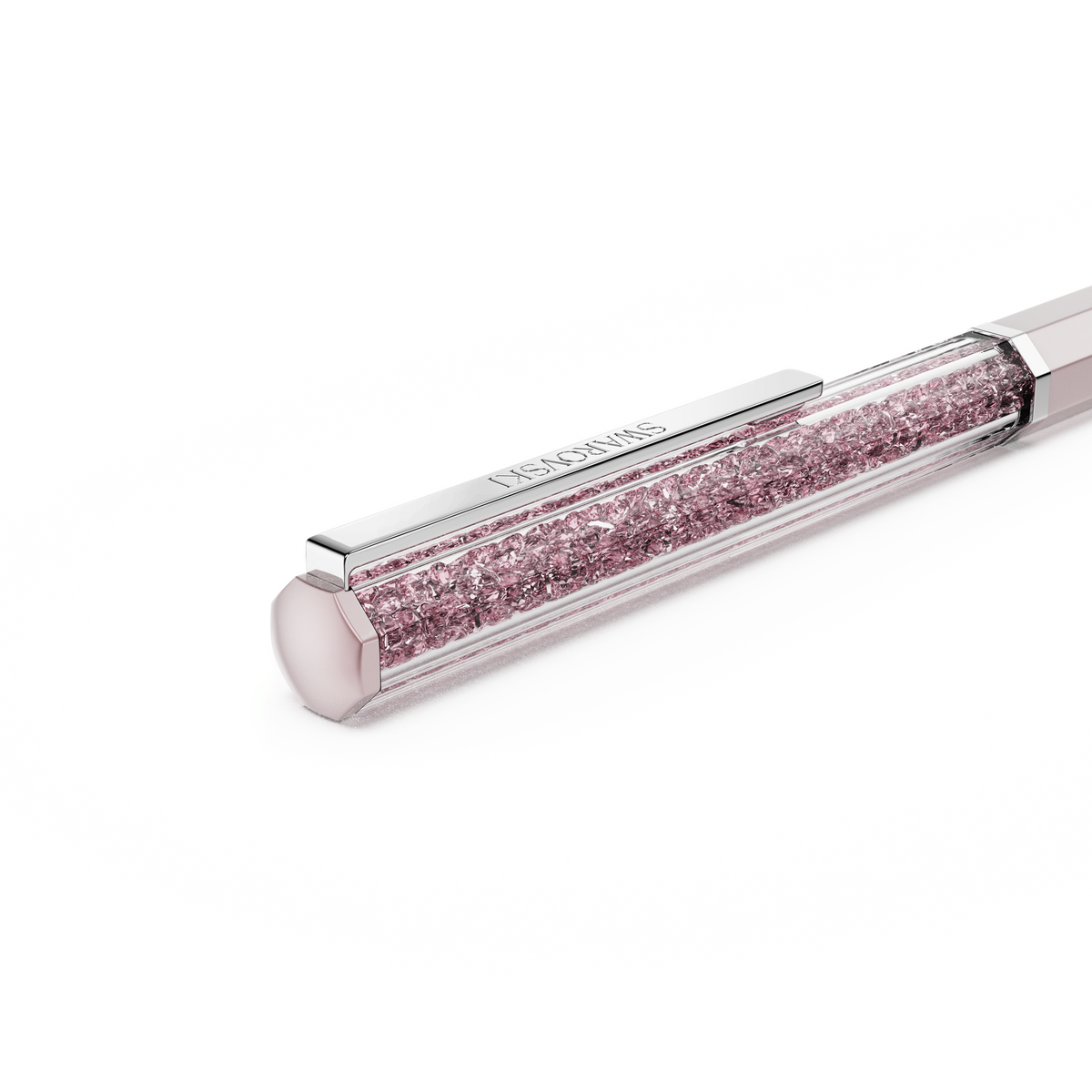 A close-up of the Swarovski Crystalline ballpoint pen, featuring pink lacquer and chrome-plated accents, filled with sparkling pink crystals against a plain white background.