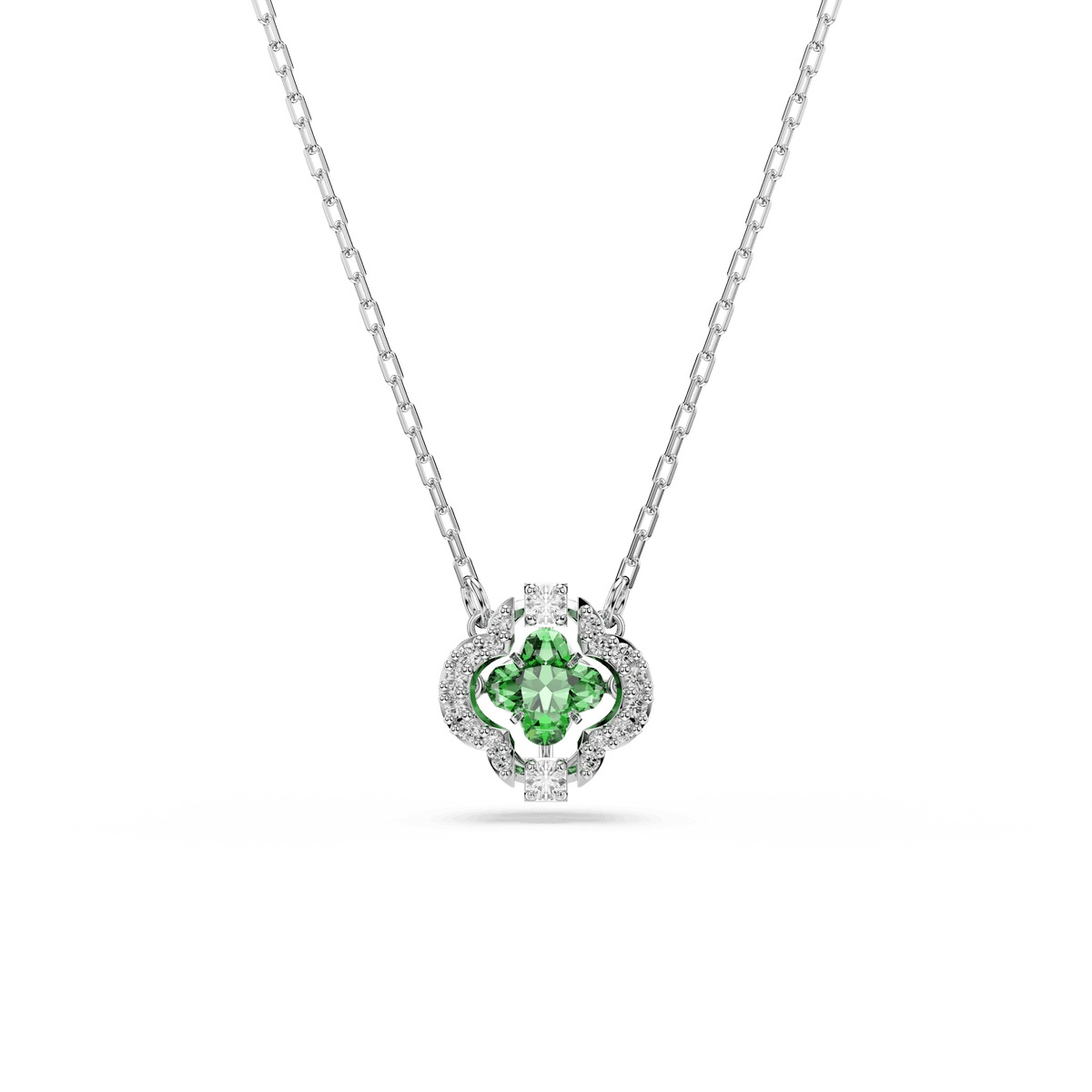 The Swarovski Una Angelic pendant features mixed-cut green Swarovski Zirconia at its center, surrounded by pavé-set clear stones in a delicate floral motif and is finished with rhodium plating. The pendant comes on a silver-tone chain and is displayed against a white background.