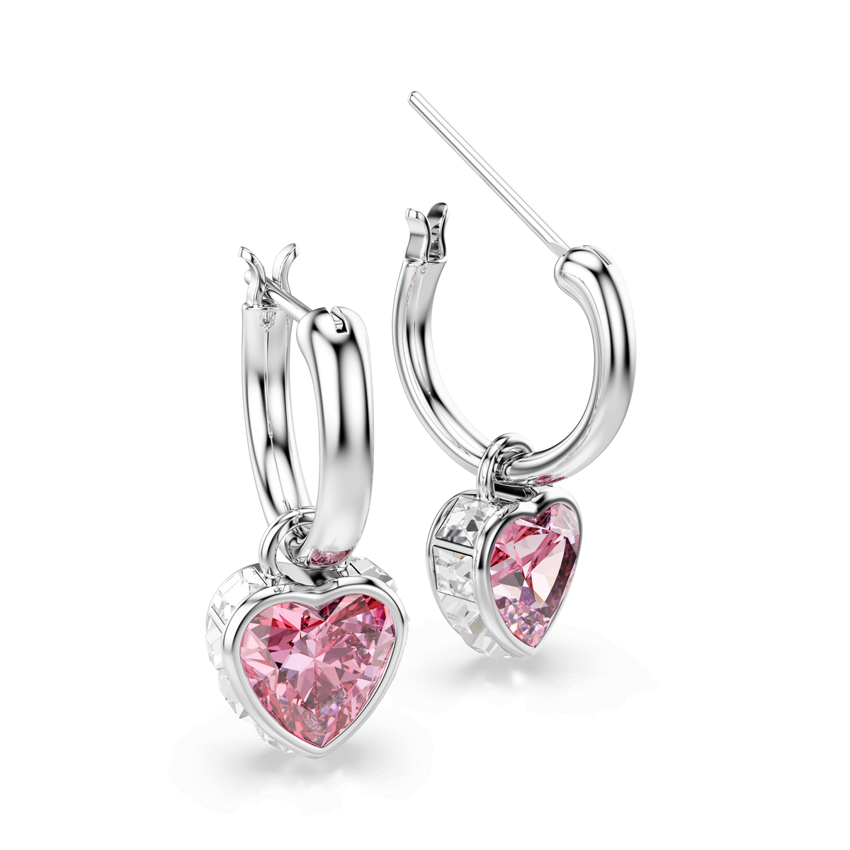 The Swarovski Chroma drop earrings feature pink heart-shaped crystals as pendants, set in rhodium-plated hoops and elegantly displayed against a plain white background.