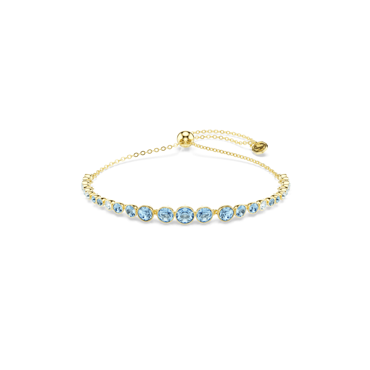 A Swarovski Imber bracelet with round blue crystals and an 18K gold finish, featuring an adjustable thin chain, is displayed on a plain white background.
