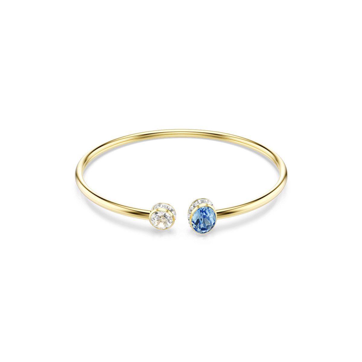 The Swarovski Chroma bangle by Swarovski features a slender 18K gold finish and an open design adorned with two gemstones at each end—one round, clear Swarovski Zirconia and one oval, blue stone—set against a plain white background.