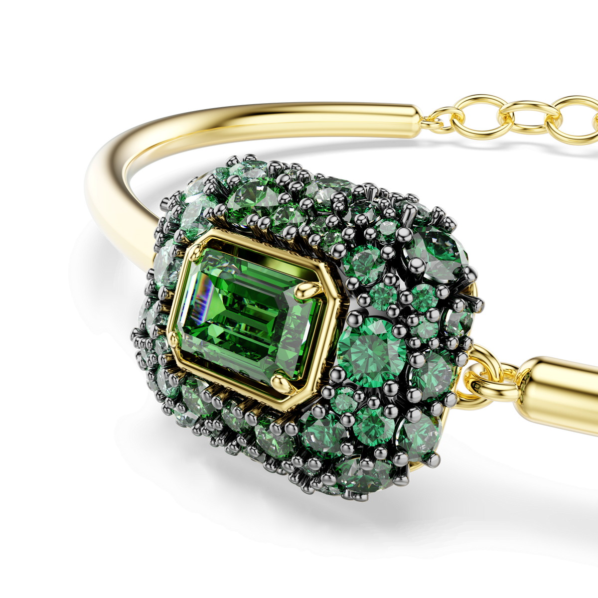 The Swarovski Sublima bangle features an octagon-cut green stone surrounded by clusters of smaller round green crystals, all set in dark prongs and finished with 18K gold, creating an elegant statement jewelry piece against a white background.