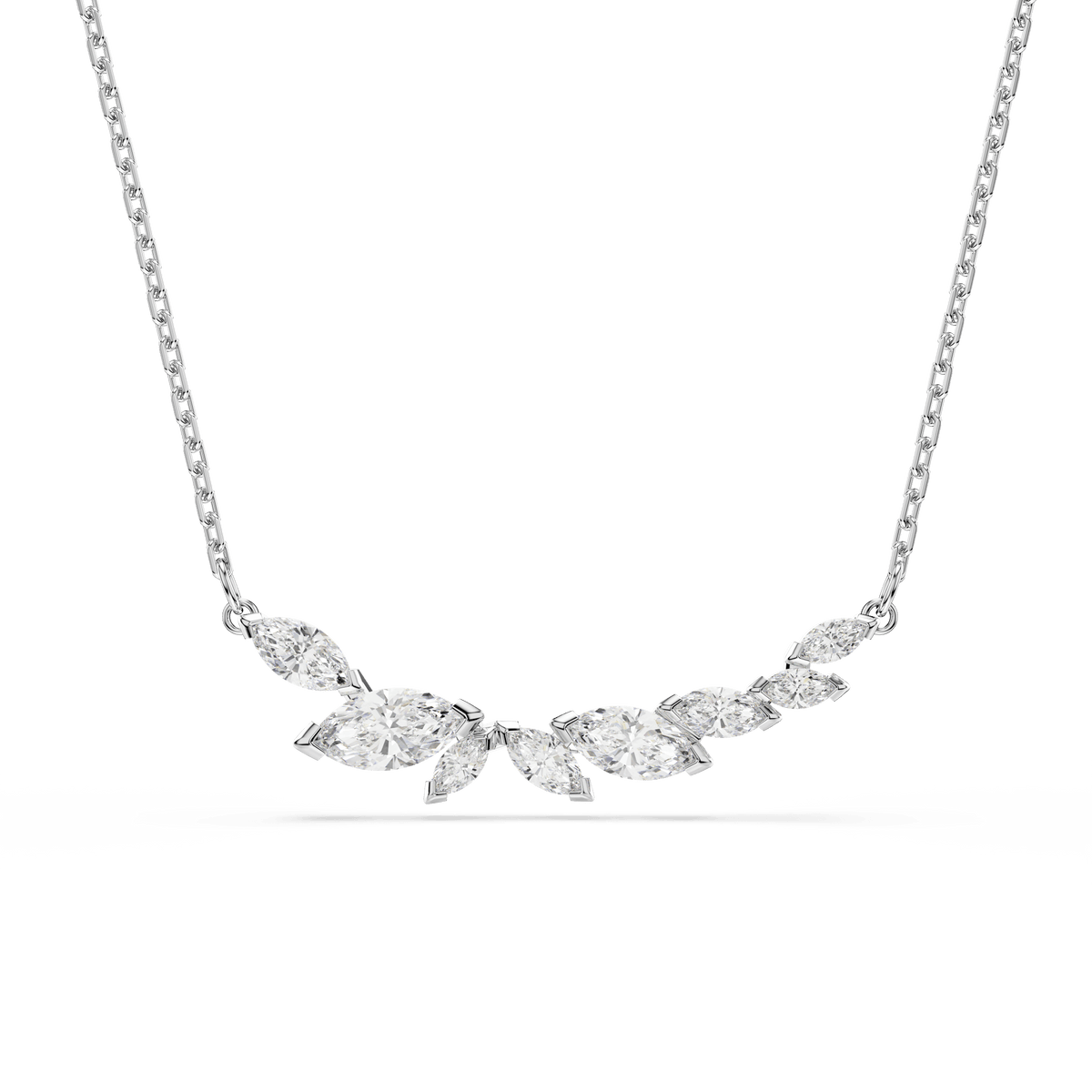 The Swarovski Mesmera necklace features a delicate rhodium-plated chain adorned with a cluster of white gemstones in various shapes, including exquisite marquise-cut Swarovski Zirconia, all elegantly arranged in a gentle curve—a stunning accessory from Swarovski perfect for any occasion.
