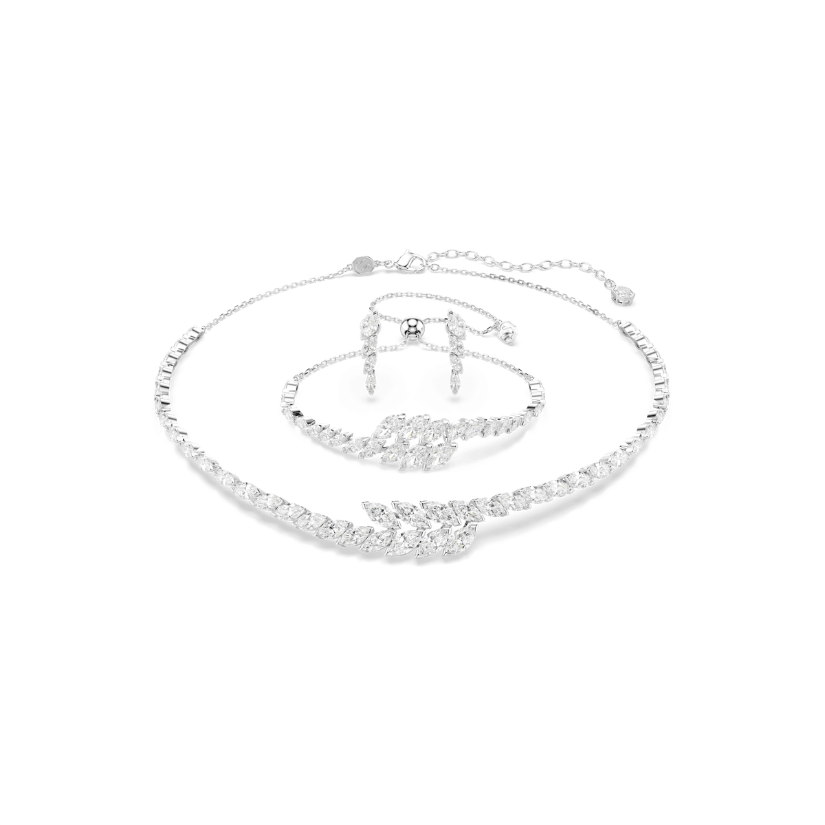 The Swarovski Mesmera set—a three-piece jewelry collection including a necklace, bracelet, and ring—features marquise-cut, clear Swarovski Zirconia gemstones set in rhodium plating. Elegantly presented on a white background, this exquisite set is perfect for holiday gifting.