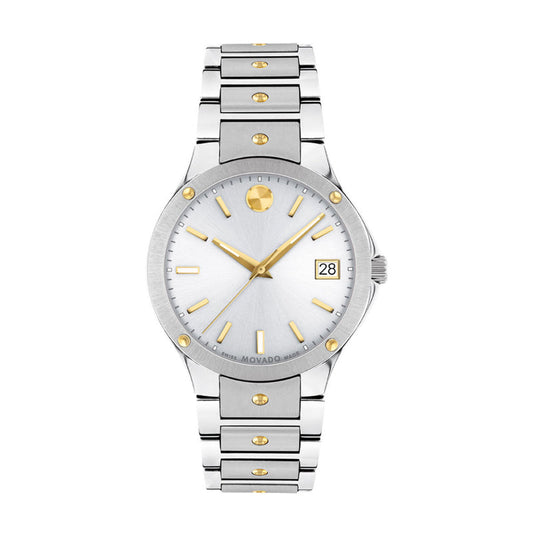 The Movado Pilot Quartz 32mm Watch features a silver and gold stainless steel case, round white dial with gold hour markers and hands, date at 3 o’clock, sapphire crystal, and a silver band with gold accents. Brand: Movado.
