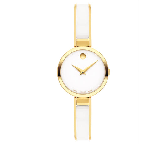 From the esteemed Movado brand, the Movado Moda Quartz 24mm Watch is a standout piece from their Moda Collection. This minimalist watch boasts a white dial highlighted by a single gold dot at the 12 o'clock position. It features slender yellow gold hour and minute hands, paired with a gold case and complemented by an elegant white ceramic and gold bracelet strap, epitomizing understated elegance.