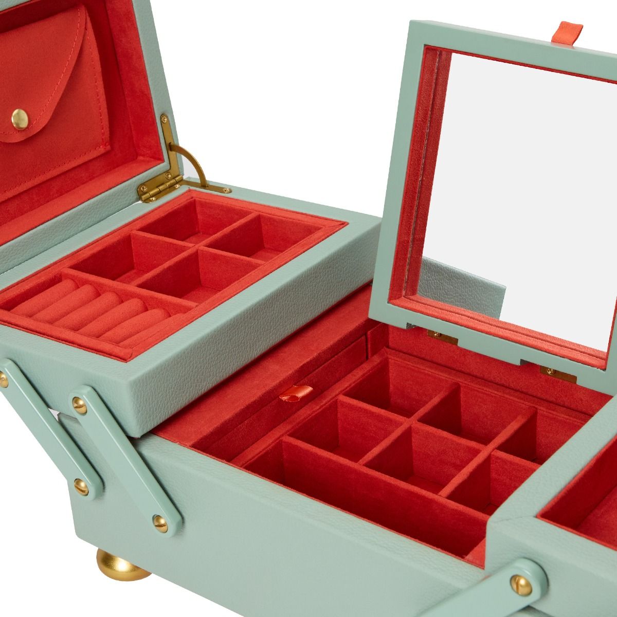 The WOLF 1834 Marla Aaron Baby Everything Jewellery Box by WOLF is crafted from vegan leather in light green, with red velvet-lined compartments, ring slots, jewelry sections, and a built-in lid mirror.