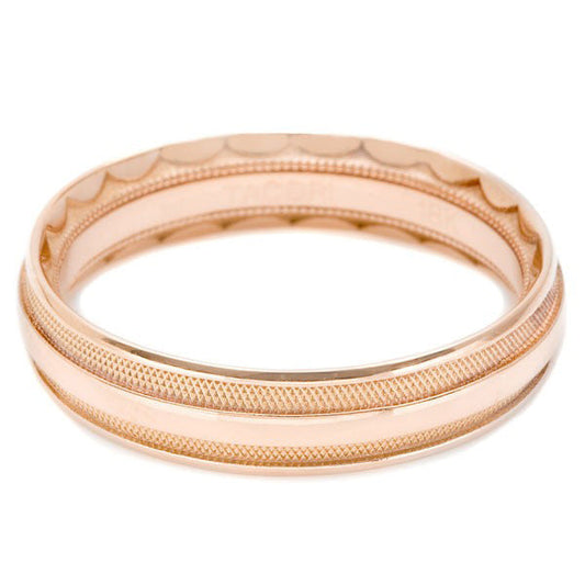Introducing the Tacori Classic High Polish Finish 18K Rose Gold Wedding Band. This exquisite piece from Tacori boasts intricate detailing on both its outer and inner surfaces, featuring a textured pattern adorned with engraved crescents for an elegant appearance. Displayed against a white background, this ring's beauty is truly highlighted.