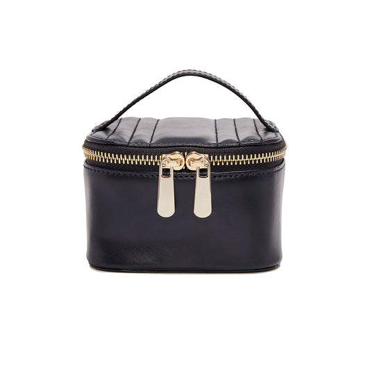 The WOLF 1834 Zip Jewellery Cube by WOLF is a chic rectangular accessory featuring a top handle and elegant quilted black leather. The two metal pulls glide smoothly along the zippered closure, while LusterLoc™ technology keeps your essentials pristine.