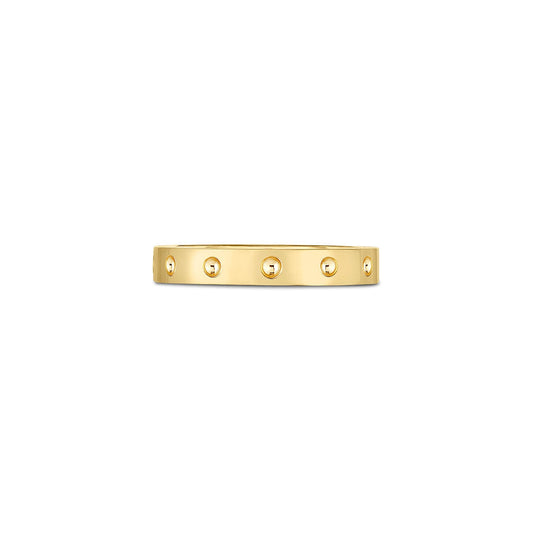 This Roberto Coin Pois Moi 18K Yellow Gold Ring showcases a smooth band adorned with evenly spaced small round studs encircling its design, set against a plain white backdrop.