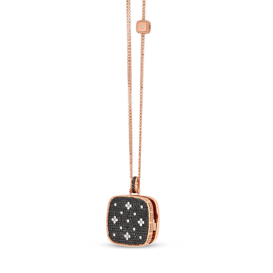 Roberto Coin's Venetian Princess Necklace showcases an 18K rose gold locket pendant adorned with black and white diamonds, featuring a delicate chain that includes a small matching square detail.