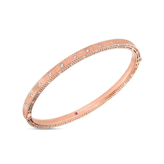 The Roberto Coin 18K Rose Gold Princess Diamond Satin Bangle features a delicate design with small, round gemstones elegantly spaced along the band.