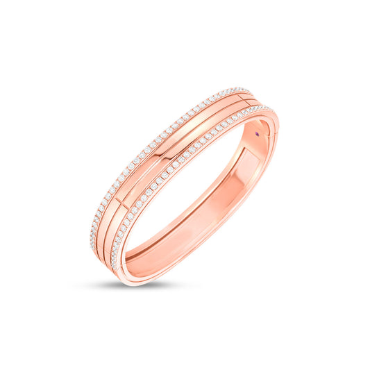 Introducing the Roberto Coin Portofino 18K Rose Gold Diamond Bangle, a stunning creation crafted in 18k rose gold. This elegant piece features a polished finish and two rows of small, sparkling diamonds along its edges, all beautifully showcased against a plain white background.