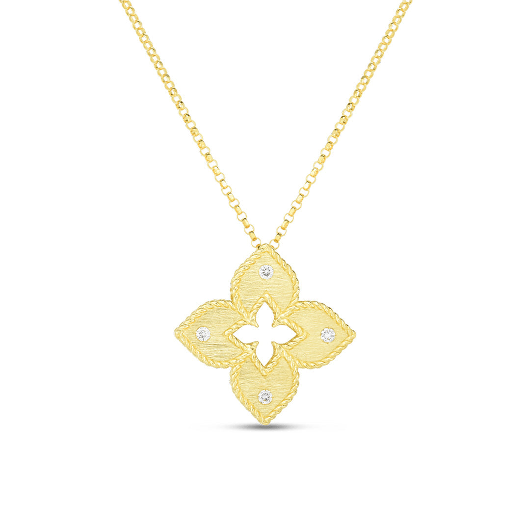 The Roberto Coin Petite Venetian Princess Necklace features an 18K yellow gold satin-finish four-petal flower pendant with diamond accents, gracefully suspended from an 18" delicate gold chain.