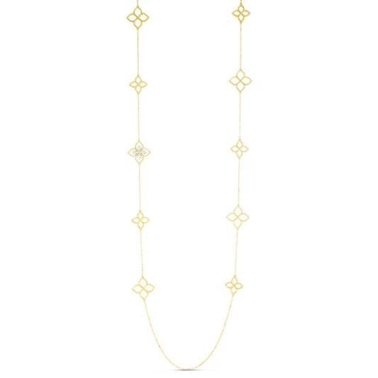 The Roberto Coin Princepessa 18K Yellow Gold Diamond Flower Station Necklace is a 34" necklace with repeating quatrefoil motifs, one accented by 0.16 TCW diamonds, shown on a plain white background.