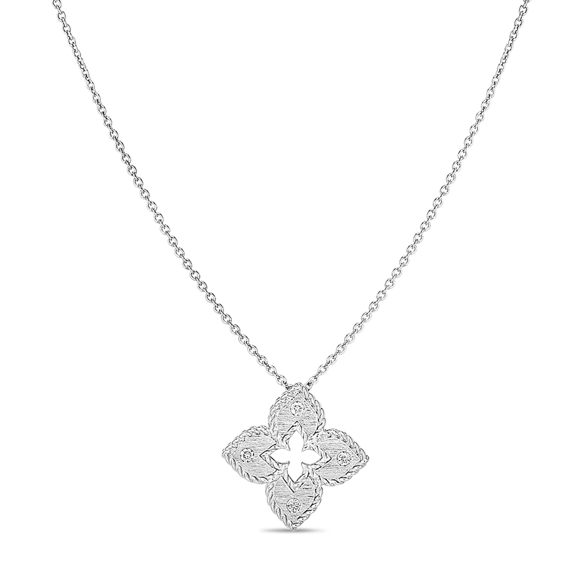 The Roberto Coin Petite Venetian Princess 18K White Gold Diamond Accent Flower Necklace Pendant features a delicate chain with a floral-shaped pendant. Its intricate detailing and symmetrical design add an elegant touch to its minimalist aesthetic. Set against a plain white backdrop, this exquisite piece of jewelry by Roberto Coin becomes a standout accessory.