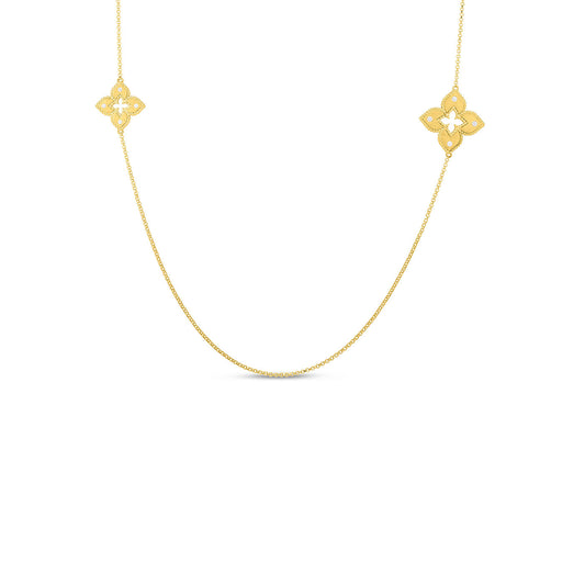 The Roberto Coin Venetian Princess 18K Yellow Gold Alternating Diamond Flowers Station Long Necklace embodies timeless elegance with its delicate chain and two symmetrical, ornate floral pendants.