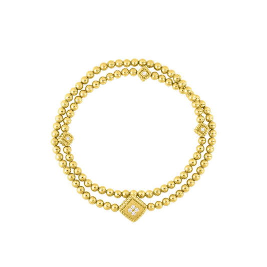 The Roberto Coin Palazzo Ducale 18K Yellow Gold Diamond Accent Double Stretch Bracelet is a breathtaking dual-strand creation, crafted in luxurious 18kt yellow gold with intricately diamond-accented square motifs elegantly interspersed among the gold beads, all set against a simple white backdrop.