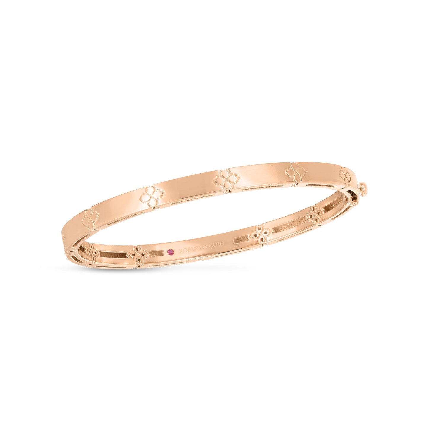 This Roberto Coin Love In Verona 18K Rose Gold Narrow Bangle is a slim bracelet adorned with a subtle floral pattern on its exterior. The design by Roberto Coin features a polished finish for a smooth, elegant appearance.