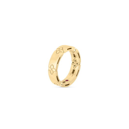 The Roberto Coin Love In Verona 18K Yellow Gold Etched Flowers Ring elegantly showcases a sleek and polished yellow gold finish, adorned with intricately etched floral designs encircling the band, highlighted by a simple white backdrop.