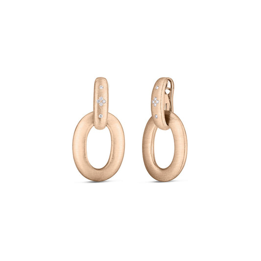 Crafted from 18K rose gold with a satin finish, the Roberto Coin Duchessa Large Doorknocker Earrings are elegantly designed with diamond accent stones near the clasp for a modern and sophisticated look.